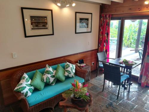 a living room with a blue couch and a table at Sokala Villas in Muri