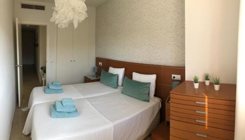 a bedroom with a bed with two towels on it at Penthouse La Paz 9 - Castle view in Moraira