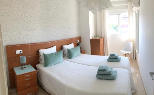 a bedroom with two beds with towels on them at Penthouse La Paz 9 - Castle view in Moraira
