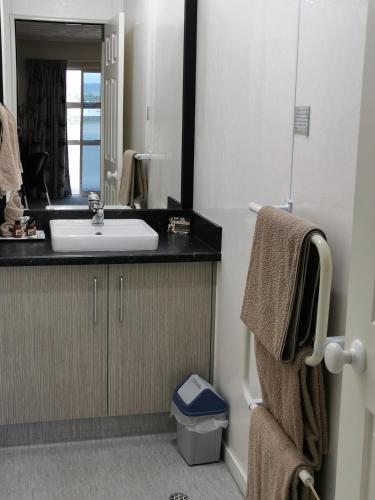 a bathroom with a sink and a mirror at Capri on Fenton in Rotorua