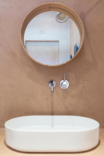 a bathroom with a white sink and a mirror at Dai Gresy - In Langa in Treiso