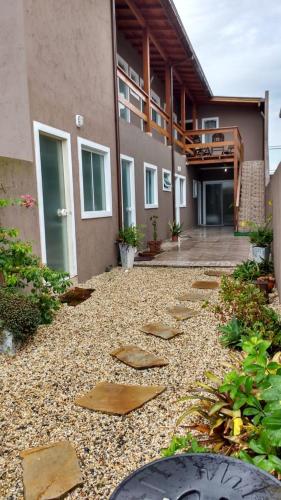 a courtyard of a building with stepping stones at Residencial da Cris in Florianópolis