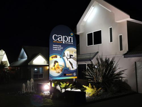 a sign in front of a house at night at Capri on Fenton in Rotorua