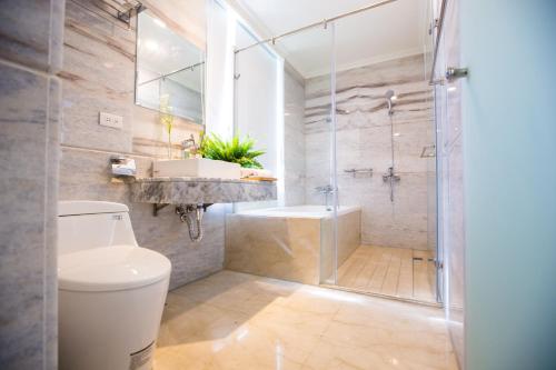 a bathroom with a toilet and a sink and a shower at Hotel Maple Taiwan Boulevard in Taichung