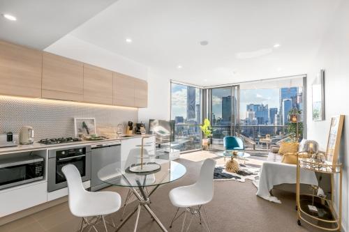 a kitchen and living room with a view of the city at Lucid Apartment South Brisbane in Brisbane