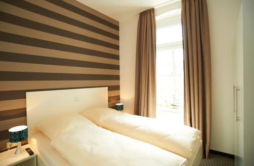 Кровать или кровати в номере Apartment Eisberg 4 mit Balkon