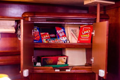 a cabinet filled with snacks on a shelf at Boat Aiolis in the Athenian Riviera! in Athens