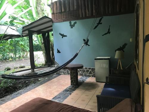 a room with a hammock on the wall at Chilamate Rainforest Eco Retreat in Puerto Viejo