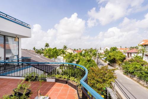 an apartment balcony with a view of a street at 5 Coconut Villa in Hoi An