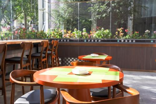 a couple of tables and chairs in a restaurant at Shanghai Menglong Hotel Management in Shanghai