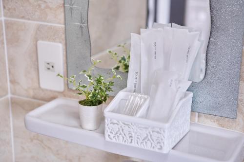 a bathroom counter with white baskets and a sink at Wind Henza in Henza