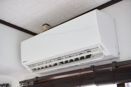 a white air conditioner on the ceiling of a room at Wind Henza in Henza