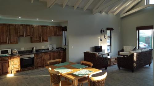 a kitchen and dining room with a table and chairs at Sunset Lagoon in Port Nolloth