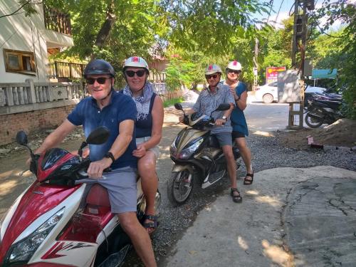a group of people riding motorcycles on a street at Lys Homestay in Ninh Binh