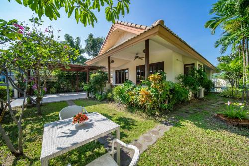 a house with a table and chairs in front of it at Blu Marine Hua Hin Resort and Villas in Hua Hin