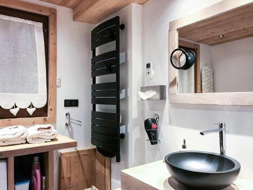 a bathroom with a black bowl sink and a mirror at Boost Your Immo Les Deux Alpes Chalet Gaspard 184 in Les Deux Alpes