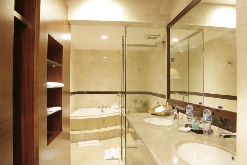 a bathroom with two sinks and a shower at ASTON Niu Manokwari Hotel & Conference Center in Manokwari