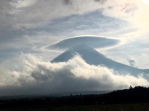 a lenticular cloud over a mountain in the sky at Guest House Zen in Yamanakako