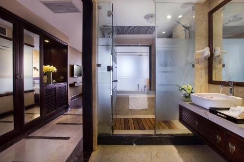 a bathroom with a tub and a sink and a shower at Golden Silk Boutique Hotel in Hanoi