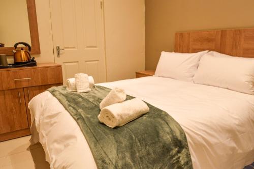 a bedroom with a bed with towels on it at Millennium hotel in Johannesburg