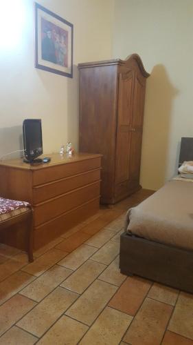 a bedroom with a dresser and a bed and a dresser with a dress at Via della Posterna in Spoleto