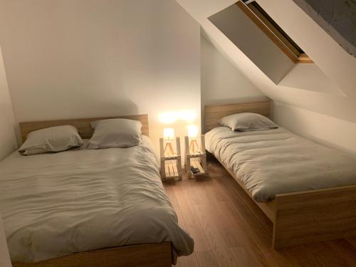 En eller flere senge i et værelse på Le Petit Chez Soi
