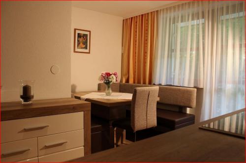 Habitación pequeña con mesa y jarrón de flores en Haus Wittwer, en Gaschurn