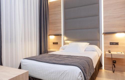 Ένα ή περισσότερα κρεβάτια σε δωμάτιο στο Hotel Liabeny