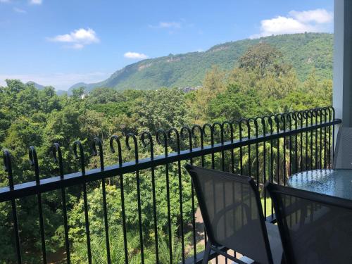 a balcony with a view of the mountains at Courtyard khaoyai by JP in Mu Si