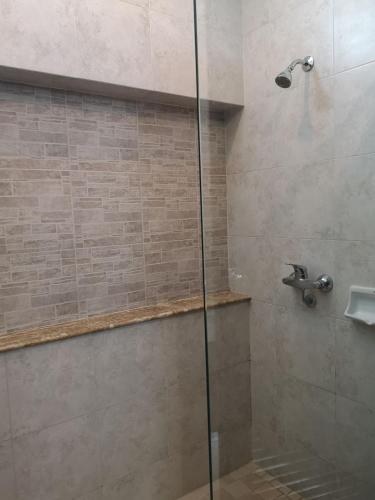 a bathroom with a shower with a glass door at Kao Tao Villa Beach Resort-Hua Hin in Khao Tao