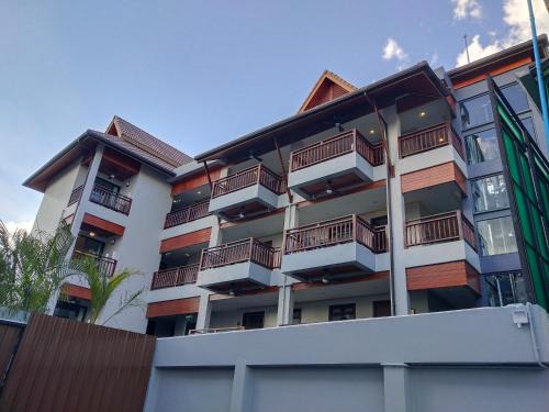 a building with balconies on the side of it at Hotel De Sripoom in Chiang Mai