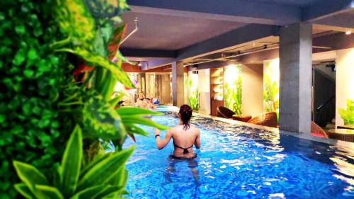 a woman in a swimming pool at a hotel at Magnolia Hotel in Da Nang