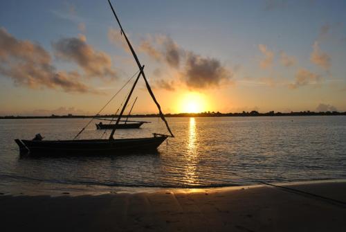 
a sailboat on a body of water at Shella White House in Lamu
