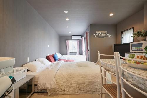 a bedroom with a bed and a desk in it at Akabane TK Building 303 in Tokyo