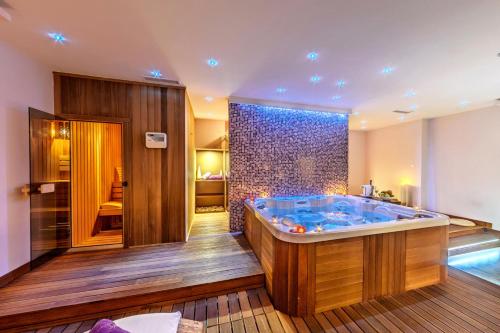 a large bathroom with a large tub in it at Sana Spa Hotel in Hisarya