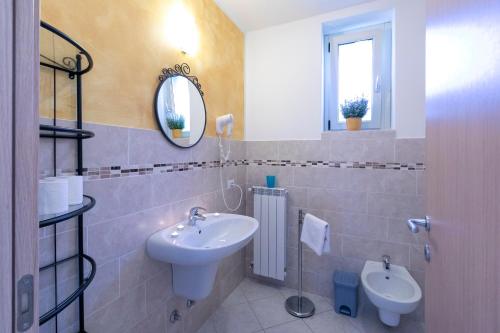 a bathroom with a sink and a mirror at La Collina dei Fiori in Vercana
