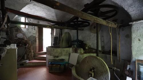 an old room with a kitchen with a ceiling at Old Mill in Pigna