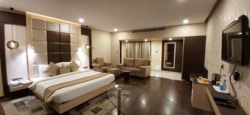 a hotel room with a bed and a television at Hotel Nataraj in Jamshedpur