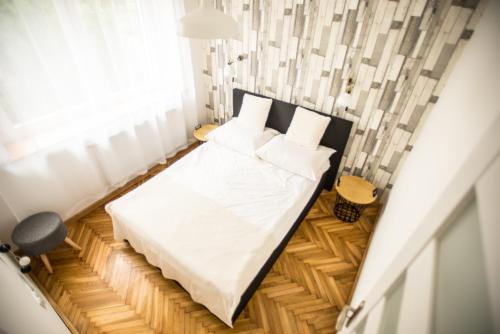 a small bedroom with a bed and a window at Apartament MANSARDA in Września