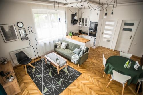 a living room with a couch and a table at Apartament MANSARDA in Września