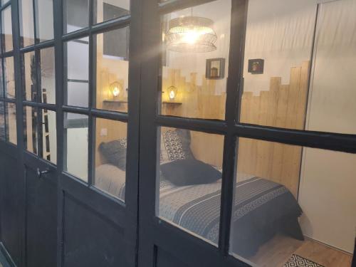 um quarto com uma cama através de uma janela em Appmt Cosy 2 pièces - Haut Standing em Baiona