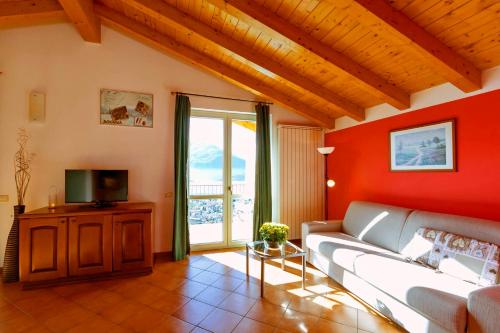 a living room with a couch and a tv at La Collina degli Ulivi in Vercana