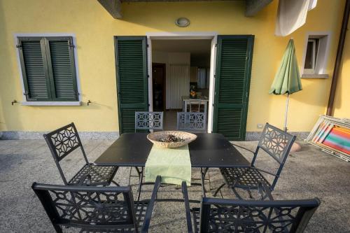a black table with chairs and a bowl on it at La Collina degli Ulivi in Vercana