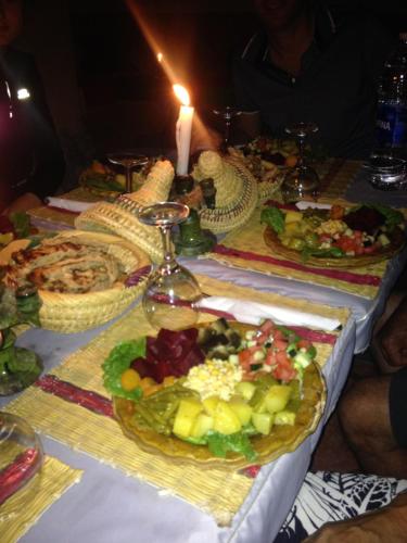 a long table with a bunch of plates of food at Riad Nkob in Nkob