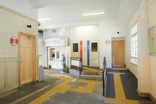 a hallway of a hospital with doors and stairs at Nipponia Hotel Koyasan Pilgrimage Railway - In the station Inn - Self Check-In Only in Kudoyama