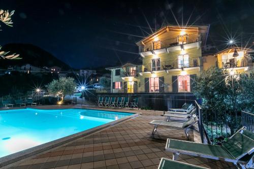 a villa with a swimming pool at night at La Collina degli Ulivi in Vercana