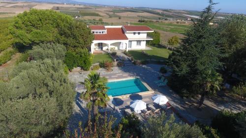 an aerial view of a house with a swimming pool at Villa Orestis Melina in Nea Iraklia