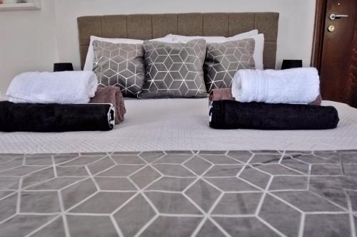 a large bed with two pillows on top of it at PMP Adamia Apartments in Peyia