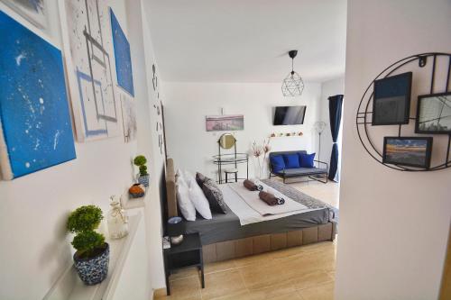 a bedroom with a bed and a living room at PMP Adamia Apartments in Peyia