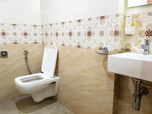 a bathroom with a toilet and a sink at Hotel Durga Elite Mumbai in Mumbai